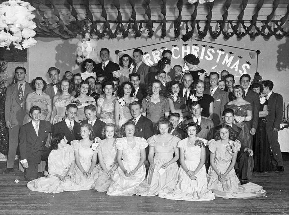 Young adults pose for an Alcatraz Christmas Party photograph
